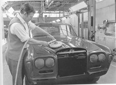 a man waxing the hood of a car