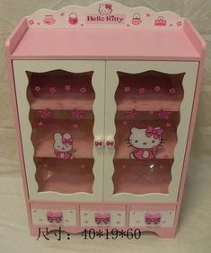 the hello kitty toy cabinet is pink and white