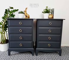 two black dressers with gold handles and brass knobs on each side, against a white wall