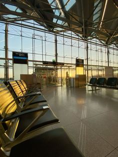 an empty airport terminal with lots of chairs