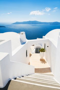 a white building with blue water in the background