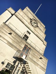 a tall white building with a clock on the top