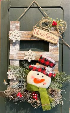 a wooden sign with a snowman hanging from it's side and christmas decorations on the front