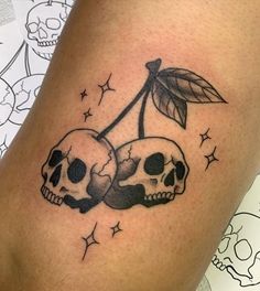 two skulls with leaves on their heads sitting next to each other