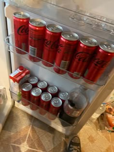 a refrigerator filled with lots of soda cans