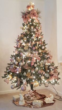 a decorated christmas tree with pink and gold ornaments