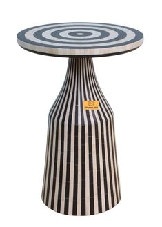 a black and white striped table sitting on top of a wooden stand with an orange tag