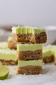 three pieces of cake sitting on top of each other with lime slices around the edges