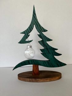 a wooden christmas tree with a glass ornament