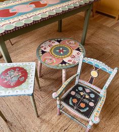 two chairs and a table with designs on them