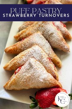 puff pastry strawberry turnoverers on a white plate with strawberries