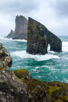 an image of the ocean with rocks in the foreground