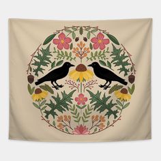 two black birds sitting on top of a flowery circle with leaves and flowers around it