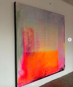 an abstract painting is displayed on the wall