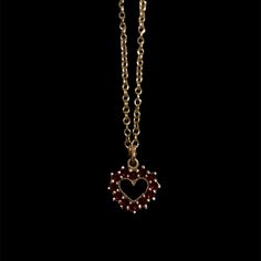 This delicate antique garnet heart necklace features rich, deep red garnets beautifully crafted into a heart shape. The garnets are encased in 14k yellow gold fill settings. The pendant hangs gracefully from a fine gold 14k yellow gold vermeil chain, adding a touch of timeless elegance to any outfit. This piece is not only a stunning example of antique jewelry but also a romantic symbol of enduring love Antique Pendant measures approx. 11mm by 13mm Features 12 approx. 1.5mm round garnets Set on a new 16" 14k yellow gold vermeil chain along with a new lobster clasp Because we do all our restoration work by hand we can offer a huge array of customization! If you have inquiries about sizing, alterations, or engraving, you can inquire about a quote here. As with all antiques, this piece is one Victorian Yellow Gold Jewelry For Valentine's Day, Victorian 14k Gold Jewelry For Valentine's Day, Red Victorian Necklace For Anniversary, Victorian 14k Gold Heart-shaped Jewelry, Victorian 14k Gold Heart Shaped Jewelry, Victorian 14k Gold Heart Jewelry, Dainty Heart Pendant Necklace With 17 Jewels, Elegant Heart-shaped Ruby Necklace, Victorian Jewelry With Heart Pendant And Charm