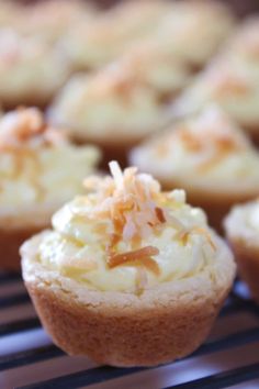 cupcakes with white frosting and shredded coconut on top