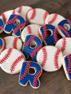 decorated cookies with blue and red baseballs are arranged in the shape of letters d