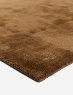 a close up view of a brown rug on a white surface with no one in it