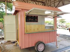 a small pink and white food cart on wheels