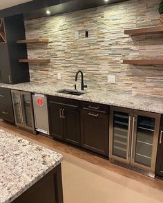 a kitchen with granite counter tops and stainless steel appliances in the center, along with built - in wine coolers