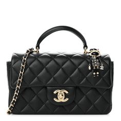 This is an authentic CHANEL Lambskin Quilted Mini Lion Charm Top Handle Rectangular Flap in Black. This stunning small shoulder bag is finely crafted of diamond quilted luxurious lambskin leather in black. The bag features a rolled leather top handle, a long polished gold chain link shoulder strap threaded with leather, a frontal flap with a polished gold Chanel Classic CC turn lock, and a Coco Chanel Lion charm. This opens to a leather interior with zipper and patch pockets. 1328188 Coco Chanel Top Handle Bag, Luxury Trendy Rectangular Flap Bag, High-end Quilted Shoulder Bag For Formal Occasions, Designer Formal Bags With Diamond Quilting, Designer Diamond Quilted Formal Bags, Elegant Leather Shoulder Bag With Diamond Quilting, Luxury Evening Bag With Diamond Quilting, Elegant Leather Bags With Diamond Quilting, Luxury Diamond Quilted Evening Bag