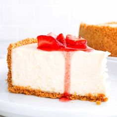 a piece of cheesecake with strawberries on top is sitting on a white plate