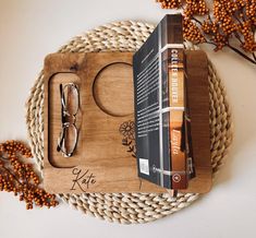 a wooden tray with some books and glasses on it