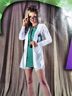 a woman in white lab coat and green dress posing for the camera with her hand on her eyeglasses