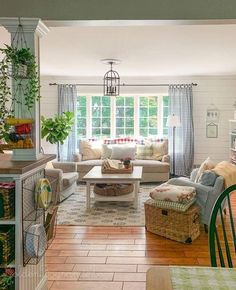 a living room filled with furniture next to a window