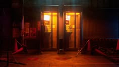 an empty parking lot at night with two doors open and red cones in the foreground