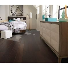 a bedroom with hardwood floors and white walls