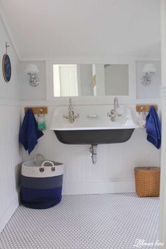 a bathroom with white walls and blue accents