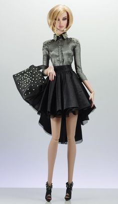 a barbie doll wearing a black dress and high heeled shoes is standing in front of a gray background