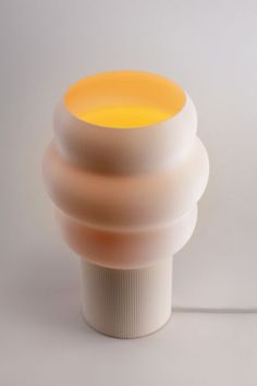 a white and yellow lamp on a table