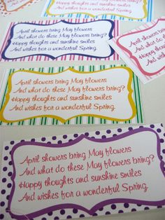 four colorful cards with different sayings on them sitting on top of a white table