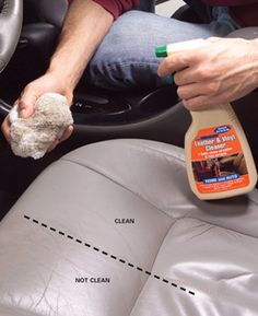 a man cleaning the inside of a car seat with a cloth and sponge on it