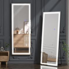 a large mirror sitting on top of a wooden floor next to a dresser and chair