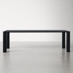 a black rectangular table sitting on top of a white floor