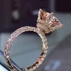 an engagement ring with pink and white diamonds on display at a jewelery showroom