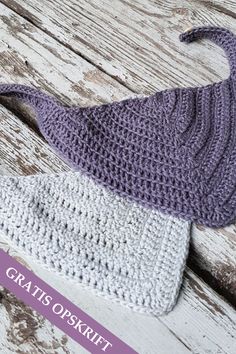 two crocheted bags sitting on top of a wooden table