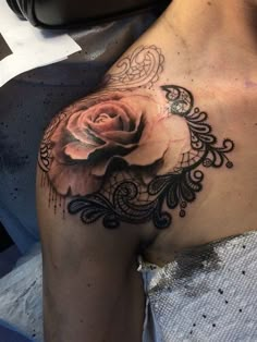 a woman's chest with a rose tattoo on the left side of her stomach