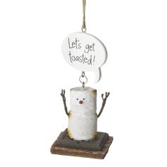 a toilet paper roll hanging from a rope with a sign that says let's get toasted