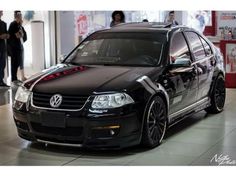 a black car parked in front of a building