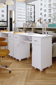 an office with white desks and yellow chairs in front of large windowed windows