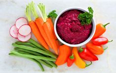 carrots, celery, radishes and other vegetables on a table