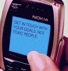 a person holding a cell phone in their left hand with the text get in touch with your goals, not toxic people