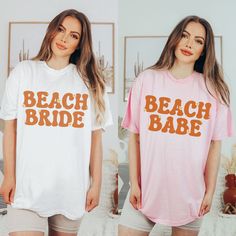 two women wearing matching beach bride and bachelor t - shirts in front of a bed