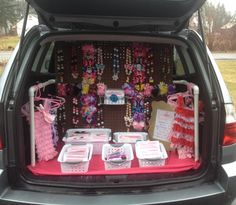 the trunk of a car is filled with items for children's birthdays and baby showers