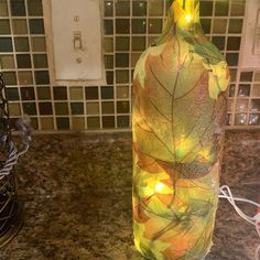 a lighted wine bottle sitting on top of a counter