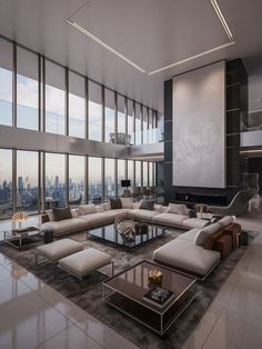 a large living room with high ceilings and floor to ceiling windows overlooking the cityscape